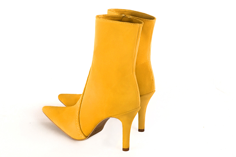 Yellow women's ankle boots with a zip on the inside. Pointed toe. High slim heel. Rear view - Florence KOOIJMAN